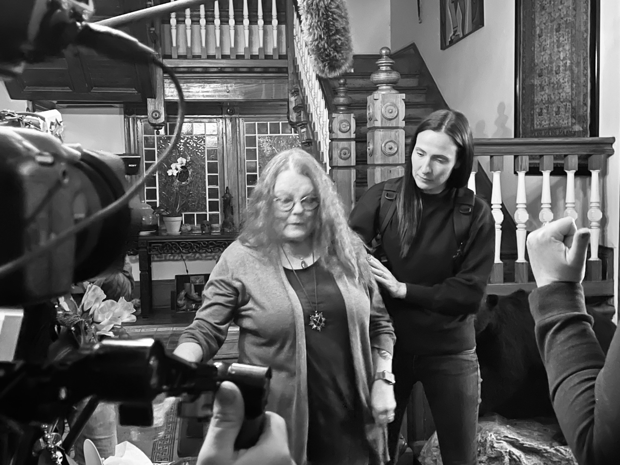 Two investigators explore an old New Orleans home as a camera records